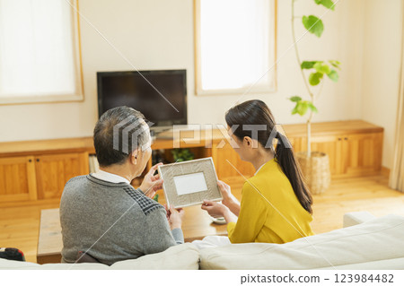elderly couple looking at photos elderly couple looking at photos 123984482