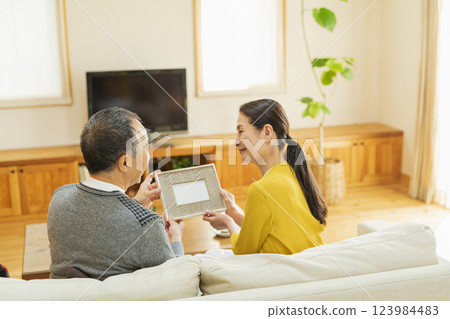 elderly couple looking at photos elderly couple looking at photos 123984483