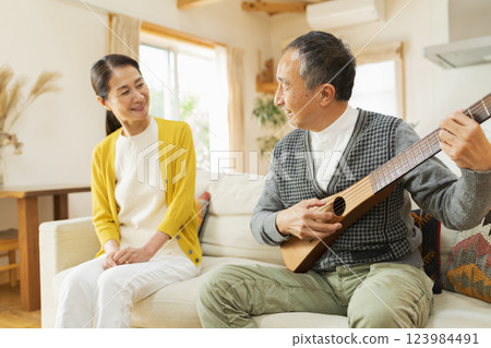 Senior man playing musical instrument at home Senior man playing musical instrument at home 123984491