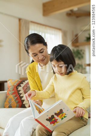 Grandmother and grandson reading a picture book Grandmother and grandson reading a picture book 123984565