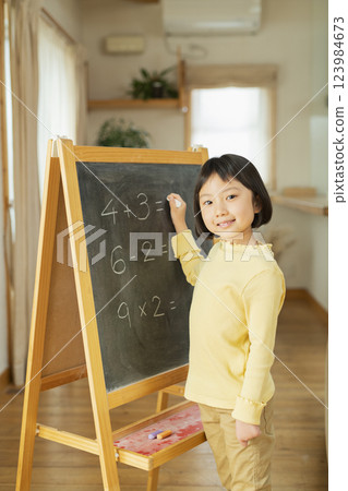 Grandchild studying in the living room 123984673