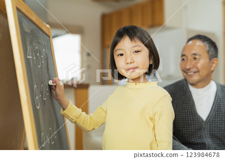Grandfather and grandson studying 123984678