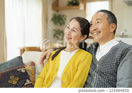 Elderly couple relaxing in the living room Elderly couple relaxing in the living room 123984850