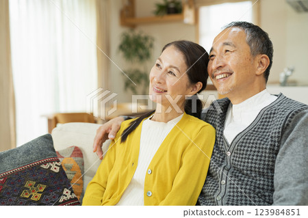 Elderly couple relaxing in the living room Elderly couple relaxing in the living room 123984851