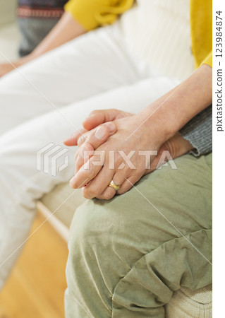 Hands of an elderly couple hugging each other Hands of an elderly couple hugging each other 123984874