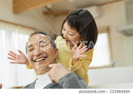 Grandfather and grandchildren playing 123984894