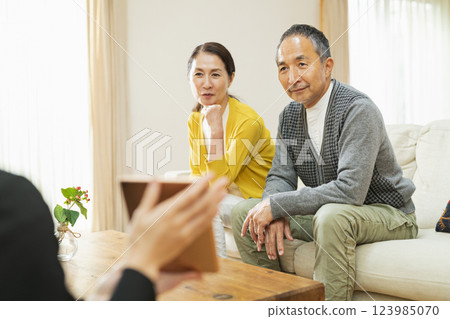 Senior couple receiving door-to-door sales Senior couple receiving door-to-door sales 123985070