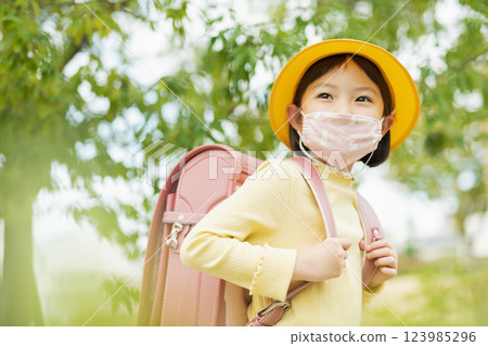 Elementary school students wearing masks and going to school Elementary school students wearing masks and going to school 123985296