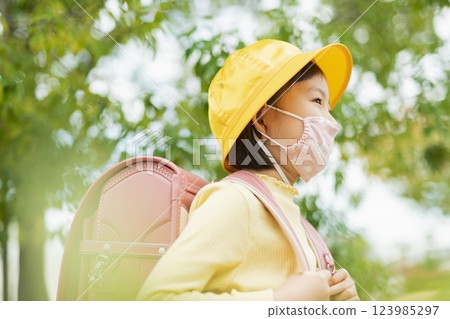 Elementary school students wearing masks and going to school Elementary school students wearing masks and going to school 123985297