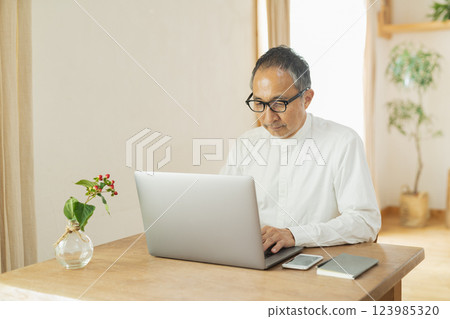 Senior man working remotely 123985320