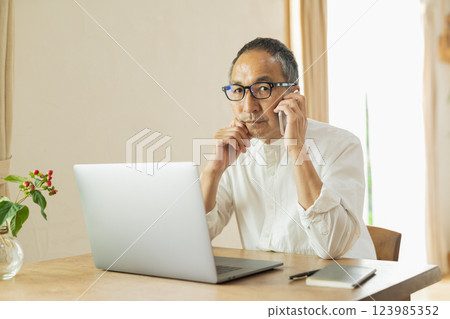 Senior man working remotely 123985352