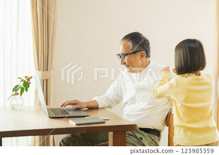 Grandfather and grandson working remotely 123985359