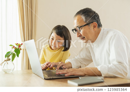 Grandfather and grandson working remotely 123985364