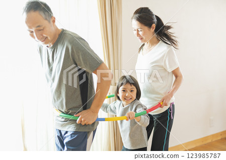 Grandparents and grandchildren exercising at home Grandparents and grandchildren exercising at home 123985787