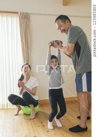 Grandparents and grandchildren exercising at home 123985803