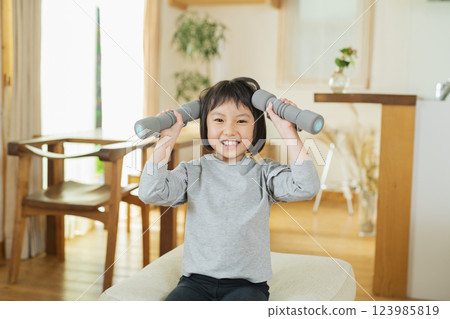Elementary school students exercising indoors 123985819