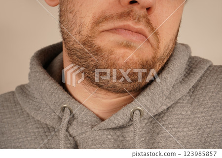 Perfect for themes of grooming and casual style. A detailed close-up of a man's chin with subtle stubble, showcasing masculine appeal. The unshaven look exudes effortless charm and simplicity. Perfect for themes of grooming and casual style. A detailed close-up of a man's chin with subtle stubble, showcasing masculine appeal. The unshaven look exudes effortless charm and simplicity. 123985857