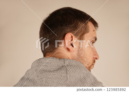 The texture of his hair is clear, and the shape of his head is emphasized. This perspective gives a mysterious and contemplative feel. A close-up of a man's head with dark hair, viewed from behind. The texture of his hair is clear, and the shape of his head is emphasized. This perspective gives a mysterious and contemplative feel. A close-up of a man's head with dark hair, viewed from behind. 123985892