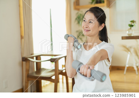 Senior woman exercising indoors Senior woman exercising indoors 123985901