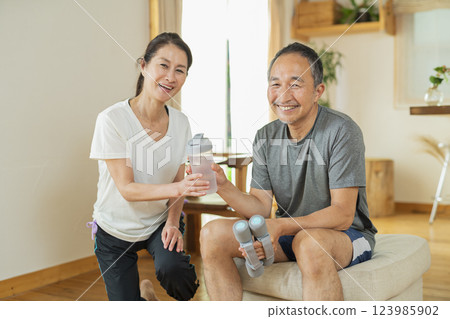 Senior couple exercising indoors 123985902