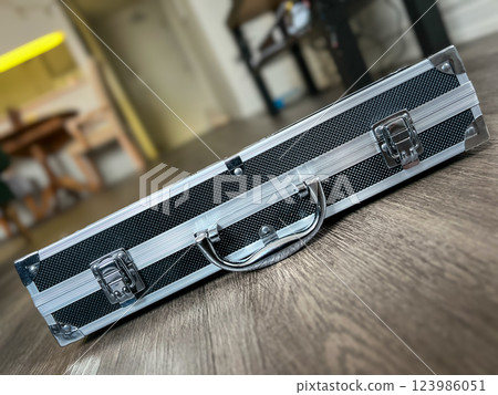 Suitcase on the wooden floor in the hotel room. Selective focus. Suitcase on the wooden floor in the hotel room. Selective focus. 123986051
