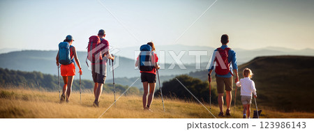 Family Hiking on a Sunny Day in a Mountainous Landscape With Scenic Views 123986143