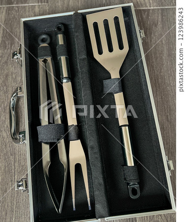 A set of kitchen utensils for cooking in a black case A set of kitchen utensils for cooking in a black case 123986243