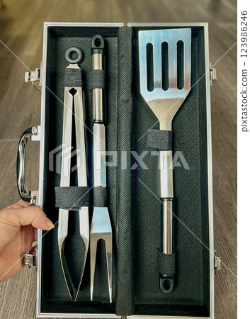 A set of kitchen utensils for cooking in a black case A set of kitchen utensils for cooking in a black case 123986246