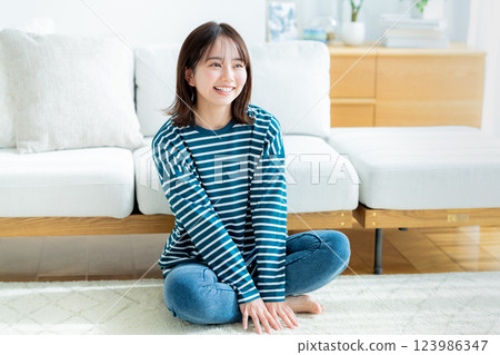 Young woman relaxing in the living room Young woman relaxing in the living room 123986347