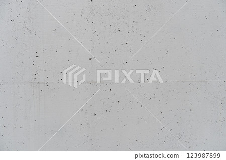 A grey wall with small holes here and there A grey wall with small holes here and there 123987899
