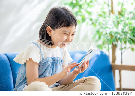 A girl watching a smartphone 123988387