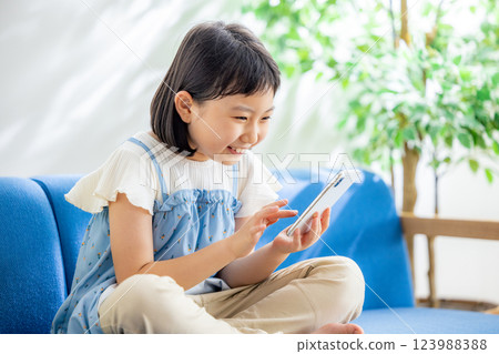 A girl watching a smartphone 123988388