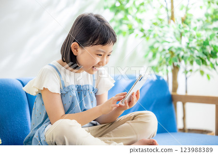 A girl watching a smartphone 123988389