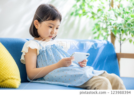 A girl watching a smartphone 123988394
