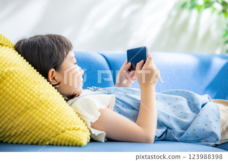 A girl watching a smartphone A girl watching a smartphone 123988398