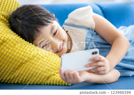 A girl watching a smartphone 123988399