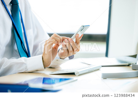 Men looking at smartphones Men looking at smartphones 123988434
