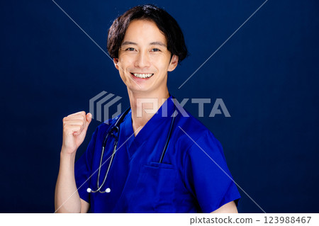 Young male doctor on black background Young male doctor on black background 123988467