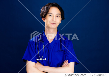 Young male doctor on black background Young male doctor on black background 123988468