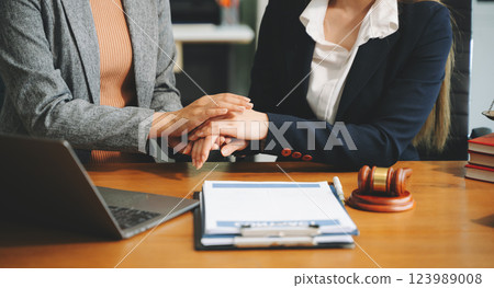 Business people compassionately holding hands and discussing contract papers 123989008