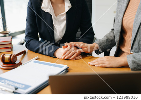 Business people compassionately holding hands and discussing contract papers 123989010