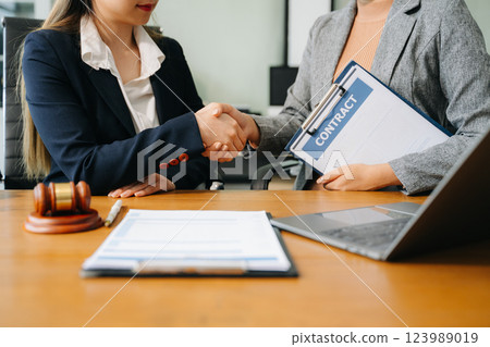 Consultation between a male lawyer and business customer, handshake after good deal agreement, Law and Legal 123989019