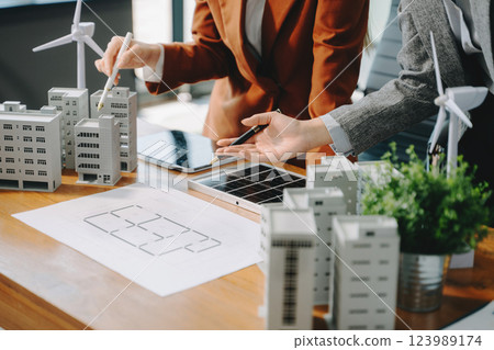 Modern office meeting of architects, designers, and developers creating innovative, sustainable housing projects 123989174