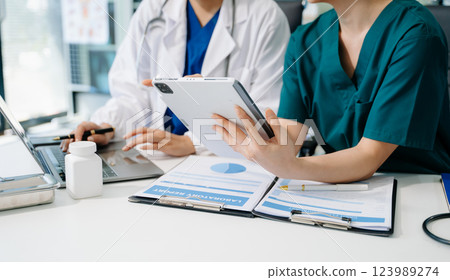 Medical technology network team meeting concept. Doctor hand working with smart phone modern digital tablet 123989274