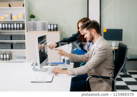 Two busy happy professional business man and woman executive leaders team using laptop working Two busy happy professional business man and woman executive leaders team using laptop working 123989370