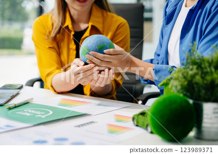 business team people planning and discussing on recycle reduce reuse policy symbol in office meeting room. business team people planning and discussing on recycle reduce reuse policy symbol in office meeting room. 123989371