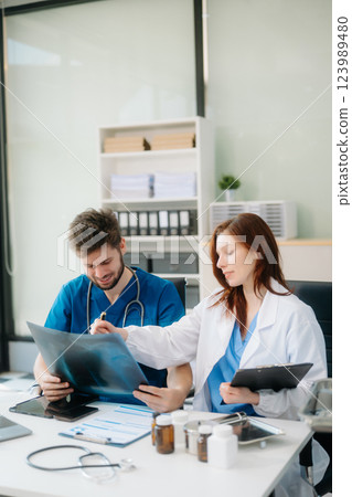 Doctors analyzing results or diagnosis of patient in clinic. Teamwork, medical and healthcare workers Doctors analyzing results or diagnosis of patient in clinic. Teamwork, medical and healthcare workers 123989480
