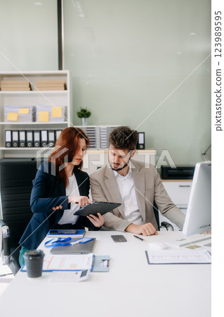 Two busy happy professional business man and woman executive leaders team using laptop working Two busy happy professional business man and woman executive leaders team using laptop working 123989595