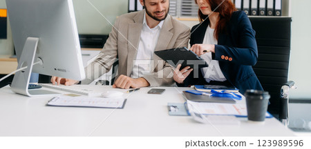 Two busy happy professional business man and woman executive leaders team using laptop working 123989596