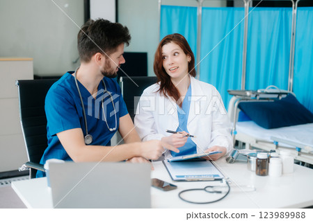 Doctors analyzing results or diagnosis of patient in clinic. Teamwork, medical and healthcare workers Doctors analyzing results or diagnosis of patient in clinic. Teamwork, medical and healthcare workers 123989988